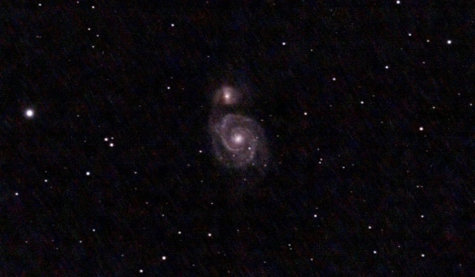 The Whirlpool Galaxy (M51), a spiral galaxy interacting with a smaller companion galaxy, 22 million light-years away
